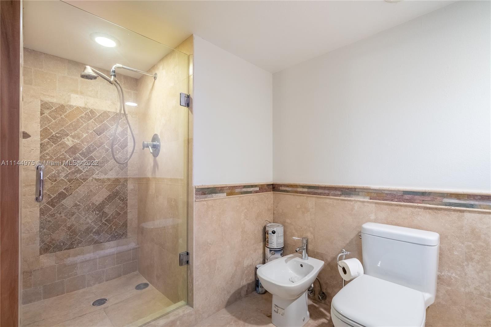 520 Brickell Key Drive, Unit A913 Miami, FL 33131 - Photo 3 of 18 a bathroom with a shower a toilet and a shower