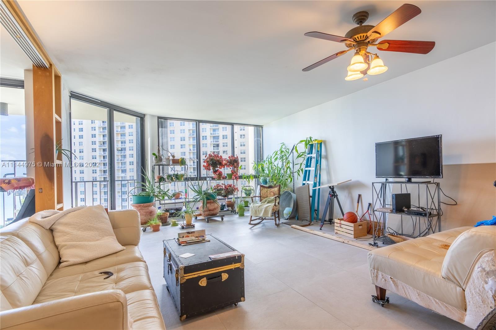 520 Brickell Key Drive, Unit A913 Miami, FL 33131 - Photo 4 of 18 a living room with furniture and a flat screen tv