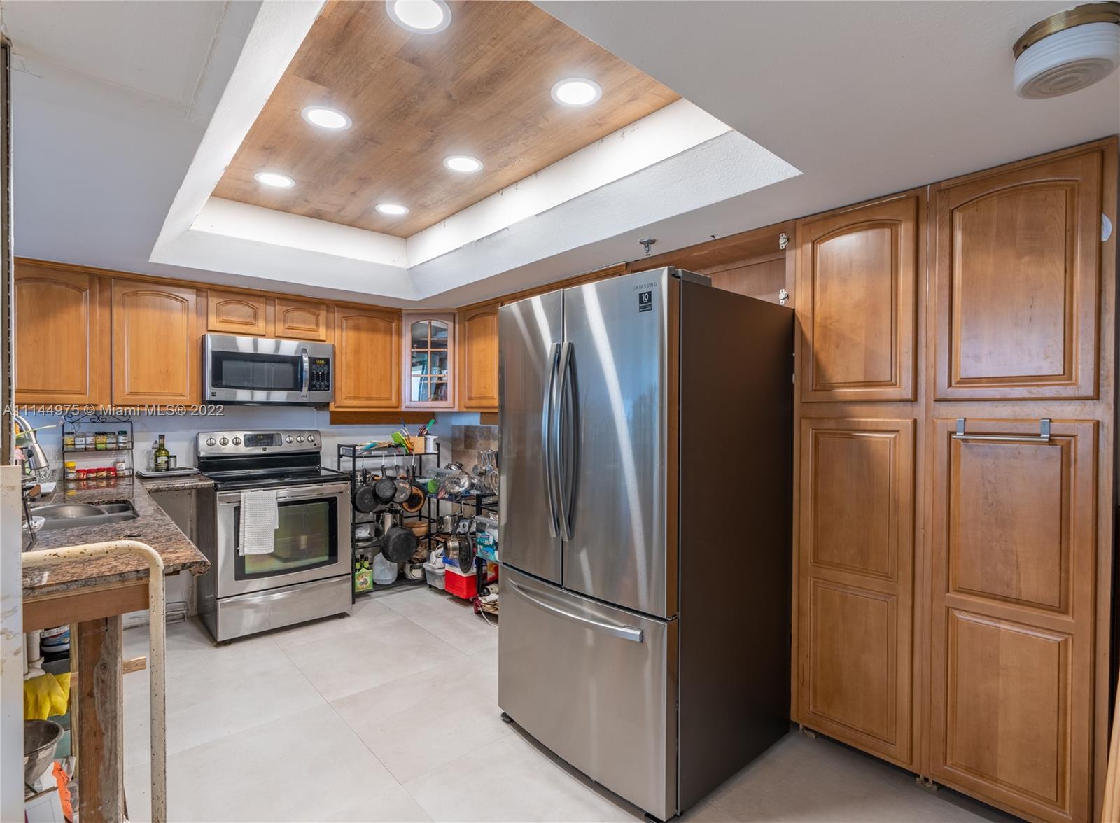 520 Brickell Key Drive, Unit A913 Miami, FL 33131 - Photo 5 of 18 a kitchen with stainless steel appliances granite countertop a refrigerator and microwave