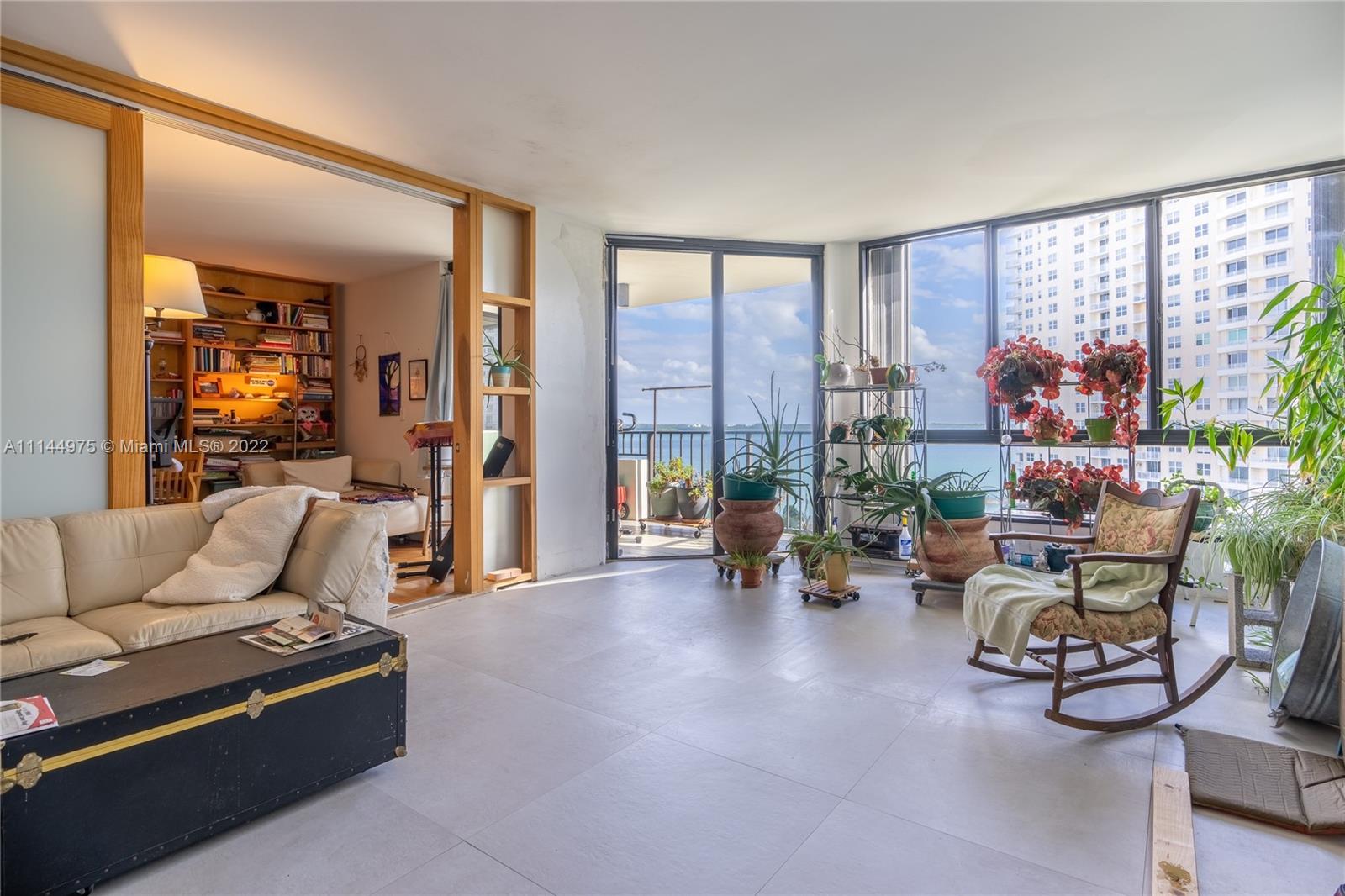 520 Brickell Key Drive, Unit A913 Miami, FL 33131 - Photo 6 of 18 a living room with furniture and a potted plant