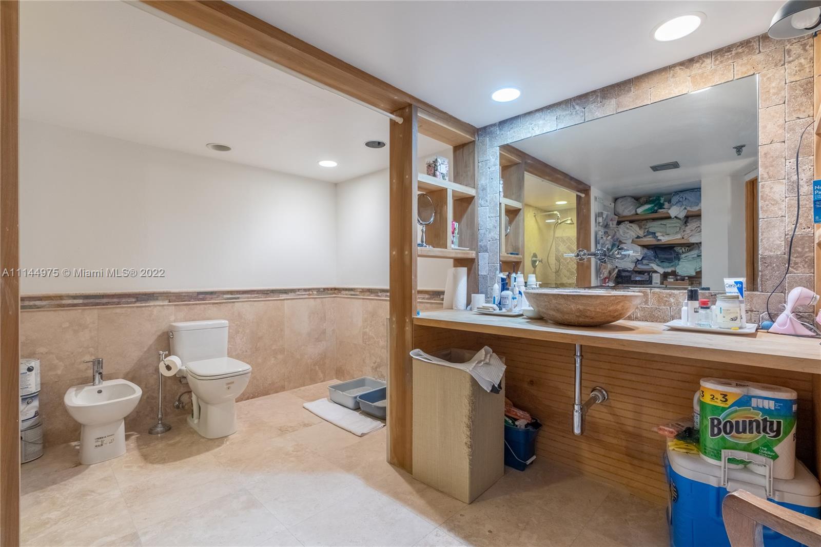 520 Brickell Key Drive, Unit A913 Miami, FL 33131 - Photo 9 of 18 a bathroom with a sink a toilet and a mirror