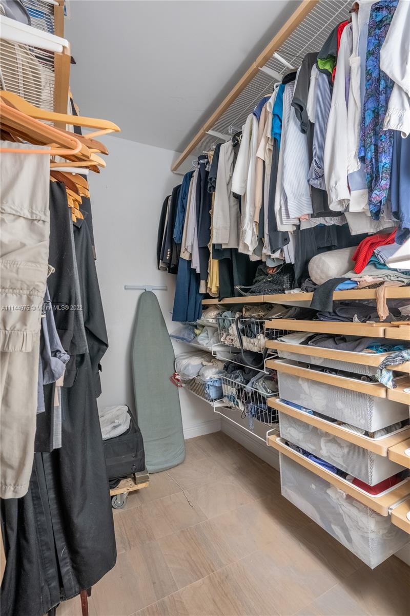 520 Brickell Key Drive, Unit A913 Miami, FL 33131 - Photo 10 of 18 a view of walk in closet with clothes and shoes