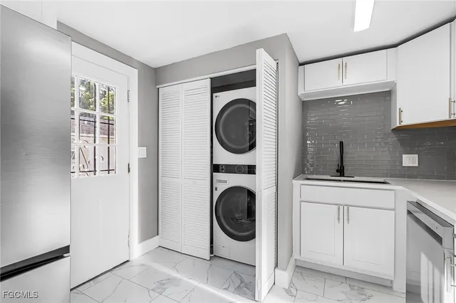 a utility room with sink dryer and washer