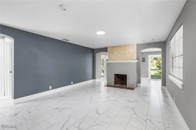 a view of a livingroom with a fireplace and window
