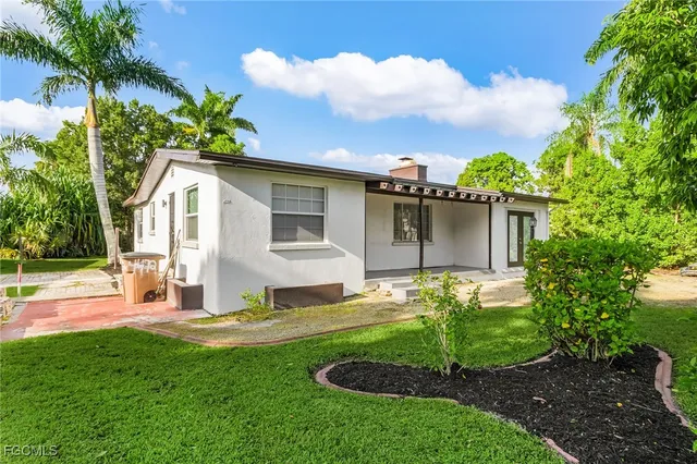 a front view of house with yard and green space