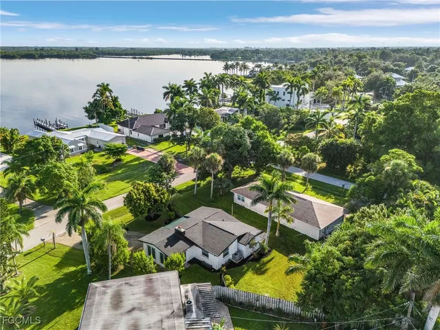 an aerial view of a house with a lake view