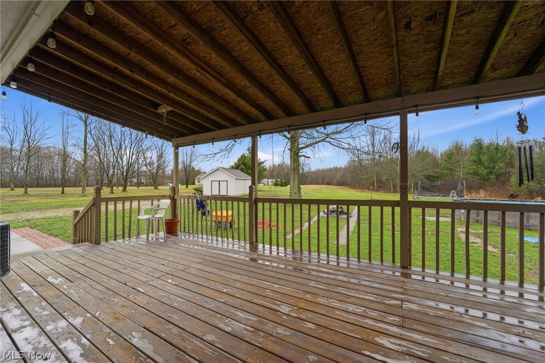 14557 Ellsworth Road Berlin Center, OH 44401 - Photo 6 of 23 Deck with a storage shed and a yard