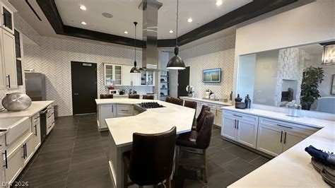 498 Pebble Run Avenue Henderson, NV 89011 - Photo 34 of 47 This chef's dream kitchen features an oversized island, ideal for both culinary creations and casual dining.