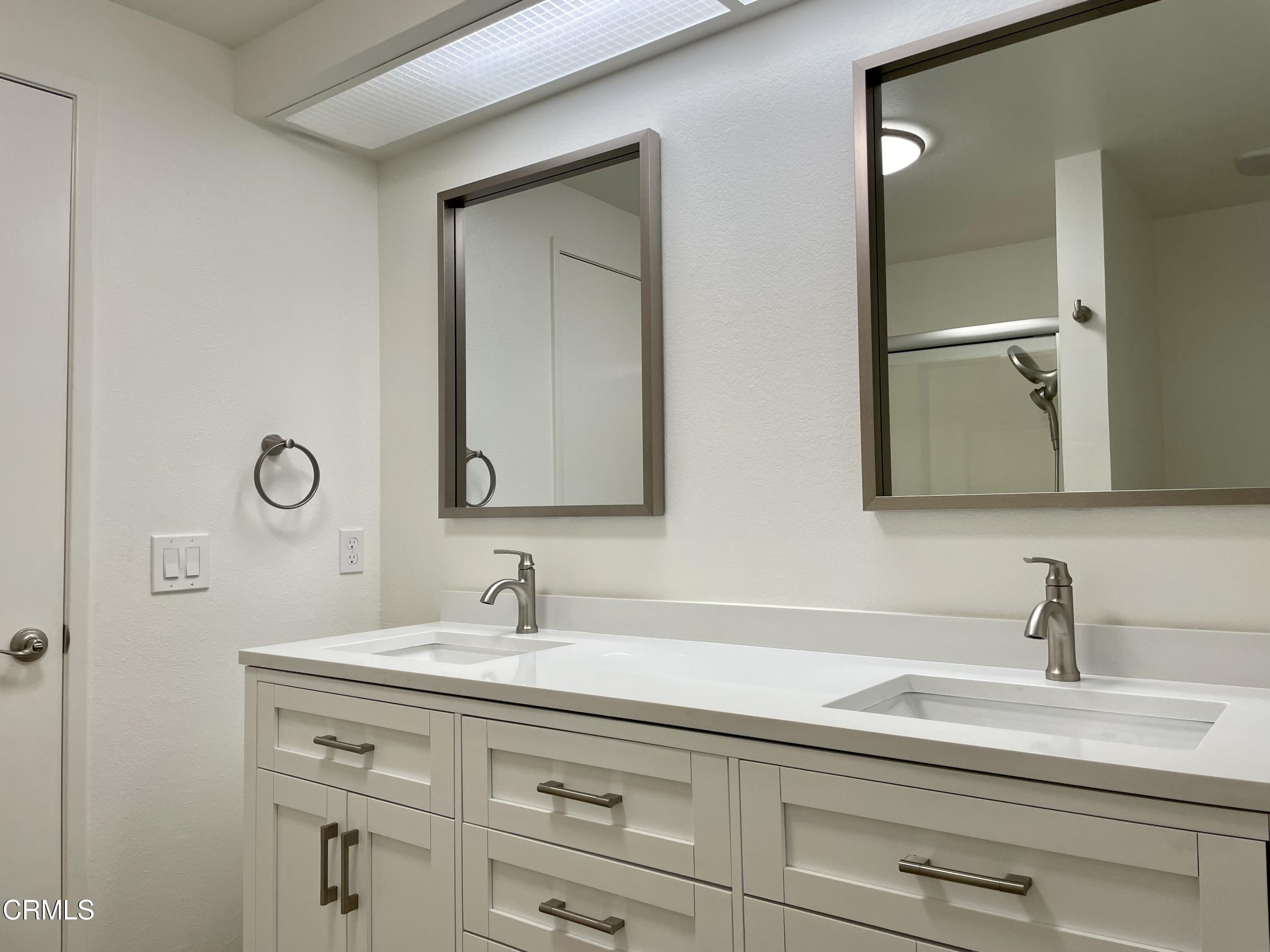 5115 Perkins Road Oxnard, CA 93033 - Photo 15 of 25 a bathroom with a double vanity sink and a mirror