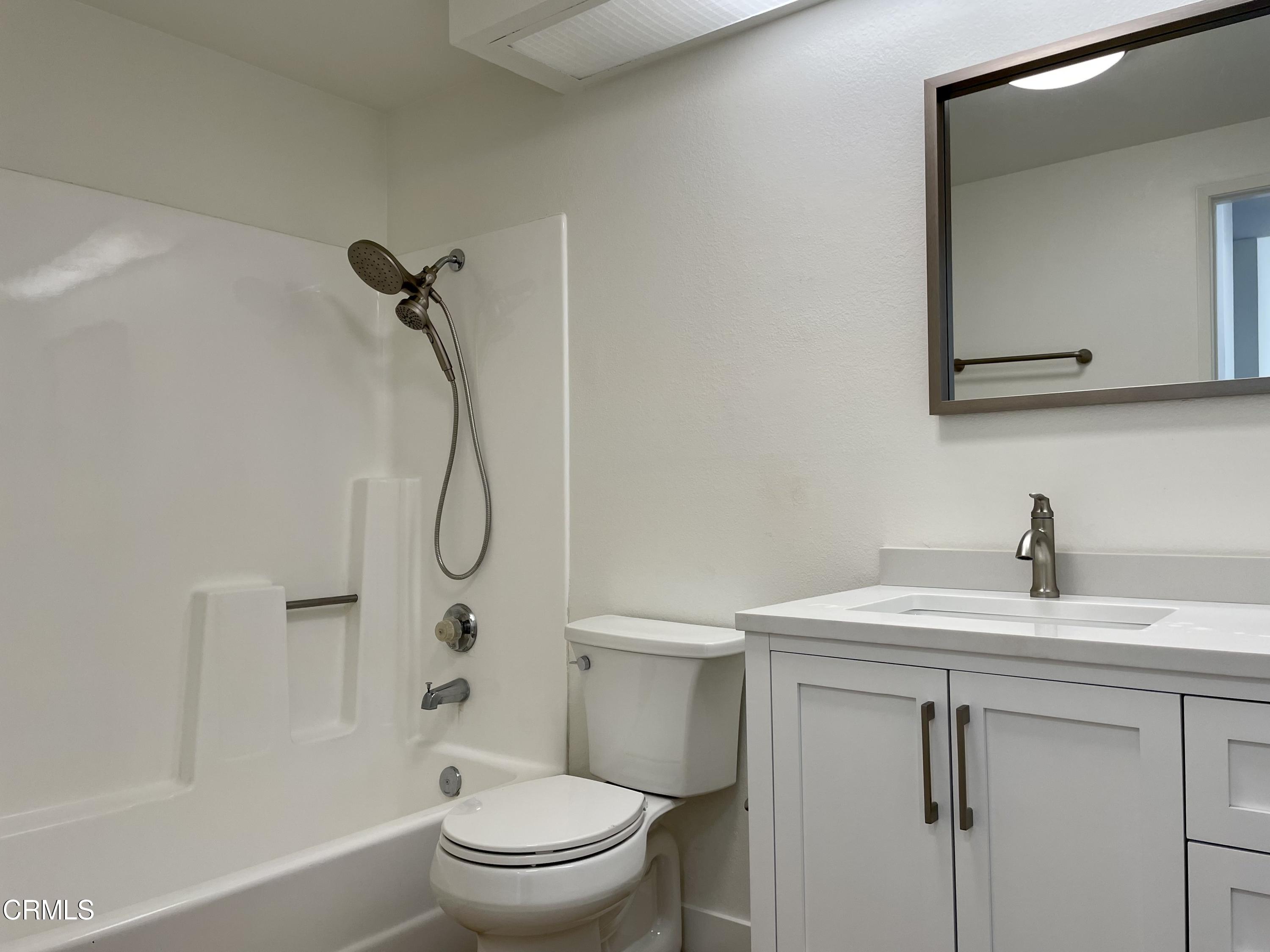 5115 Perkins Road Oxnard, CA 93033 - Photo 17 of 25 a bathroom with a granite countertop sink toilet and shower