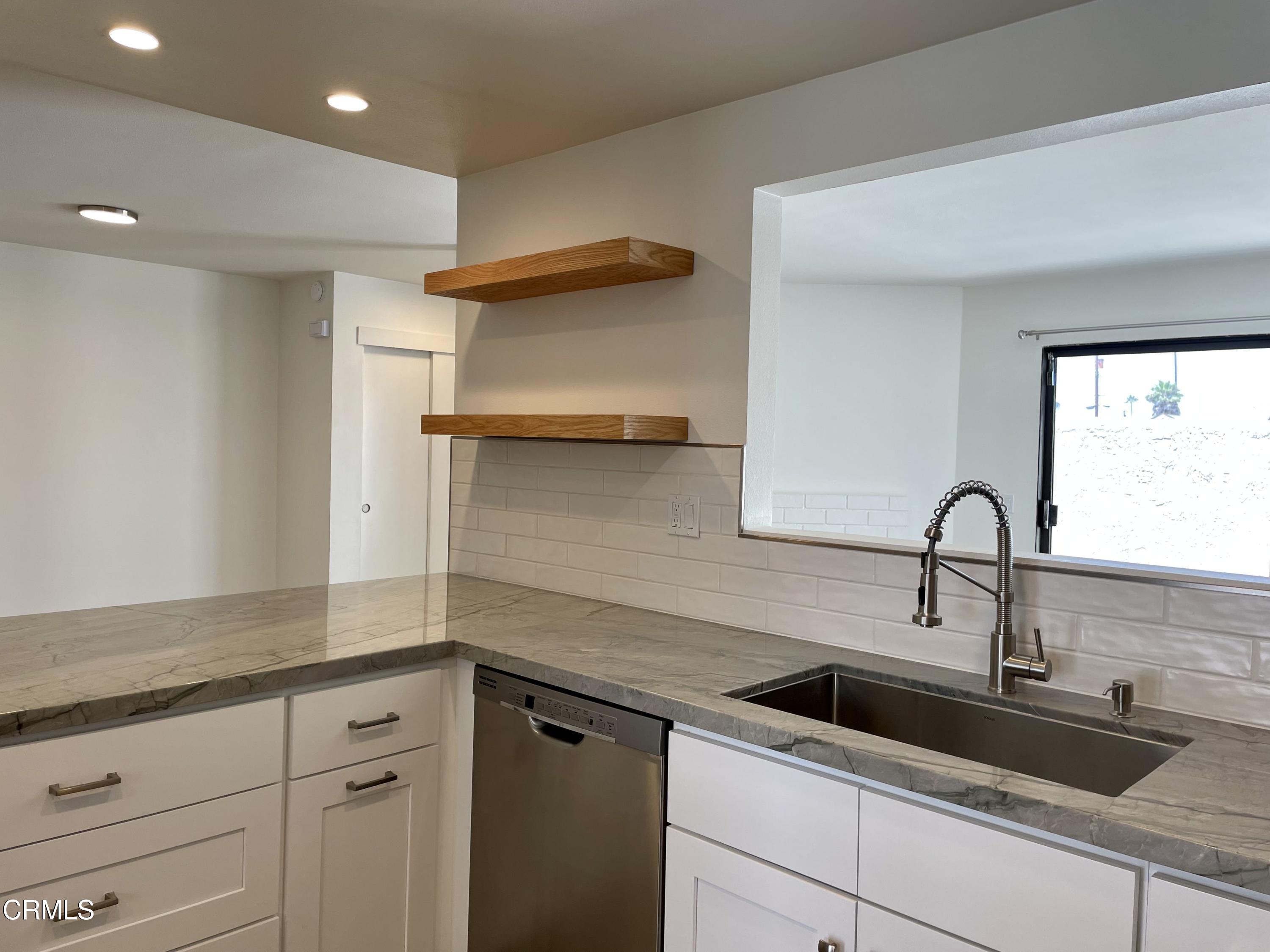 5115 Perkins Road Oxnard, CA 93033 - Photo 8 of 25 a kitchen with a sink and cabinets