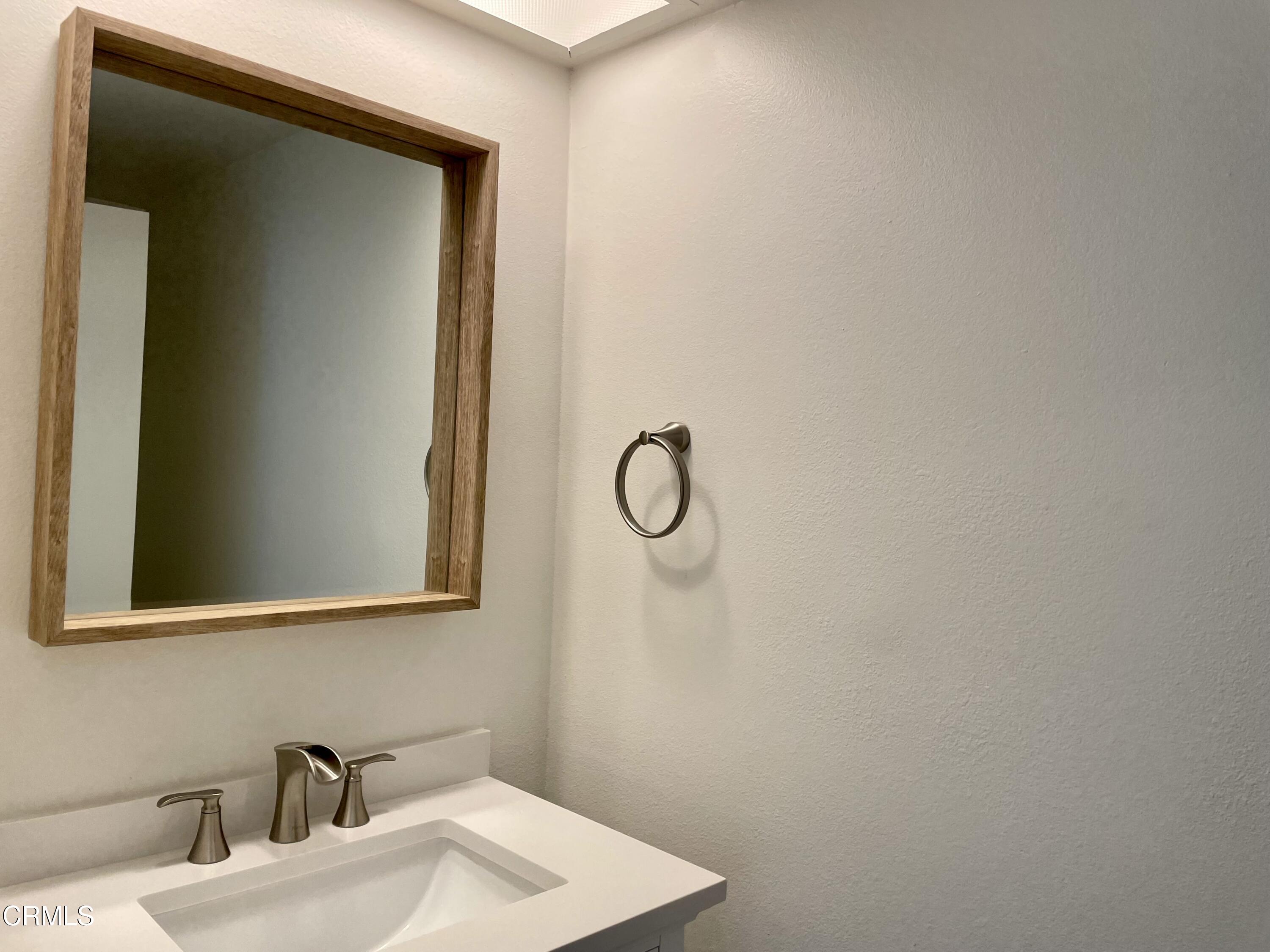 5115 Perkins Road Oxnard, CA 93033 - Photo 10 of 25 a bathroom with a sink and a mirror