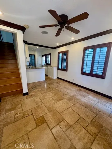 a view of a livingroom with wooden floor and a ceiling fan