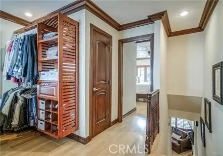 a view of a hallway with closet and a projector screen