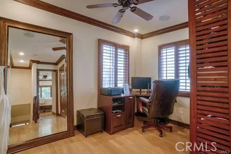a view of a workspace with furniture and a window