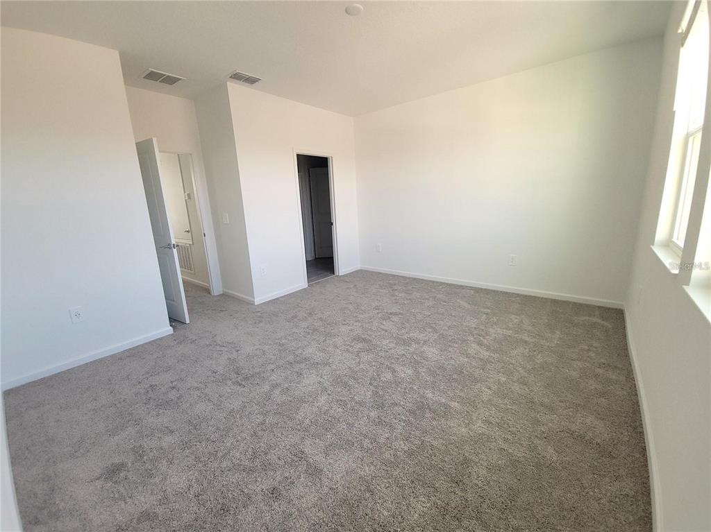 6182 Shavasana Road Clermont, FL 34714 - Photo 17 of 30 an empty room with windows