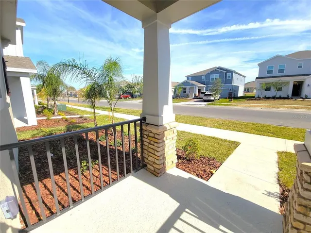 a view of balcony with wooden floor and outdoor seating