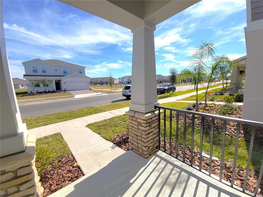 6182 Shavasana Road Clermont, FL 34714 - Photo 25 of 30 a view of a balcony with floor to ceiling windows with wooden floor
