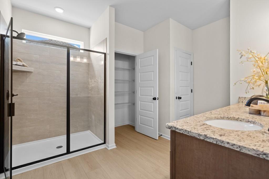 124 Sycamore Lane Calhoun, GA 30701 - Photo 28 of 43 a bathroom with a granite countertop sink a mirror and shower