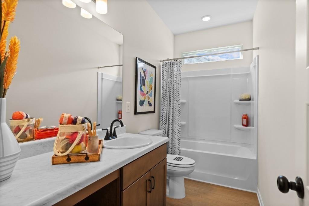 124 Sycamore Lane Calhoun, GA 30701 - Photo 33 of 43 a bathroom with a tub shower sink vanity and a toilet