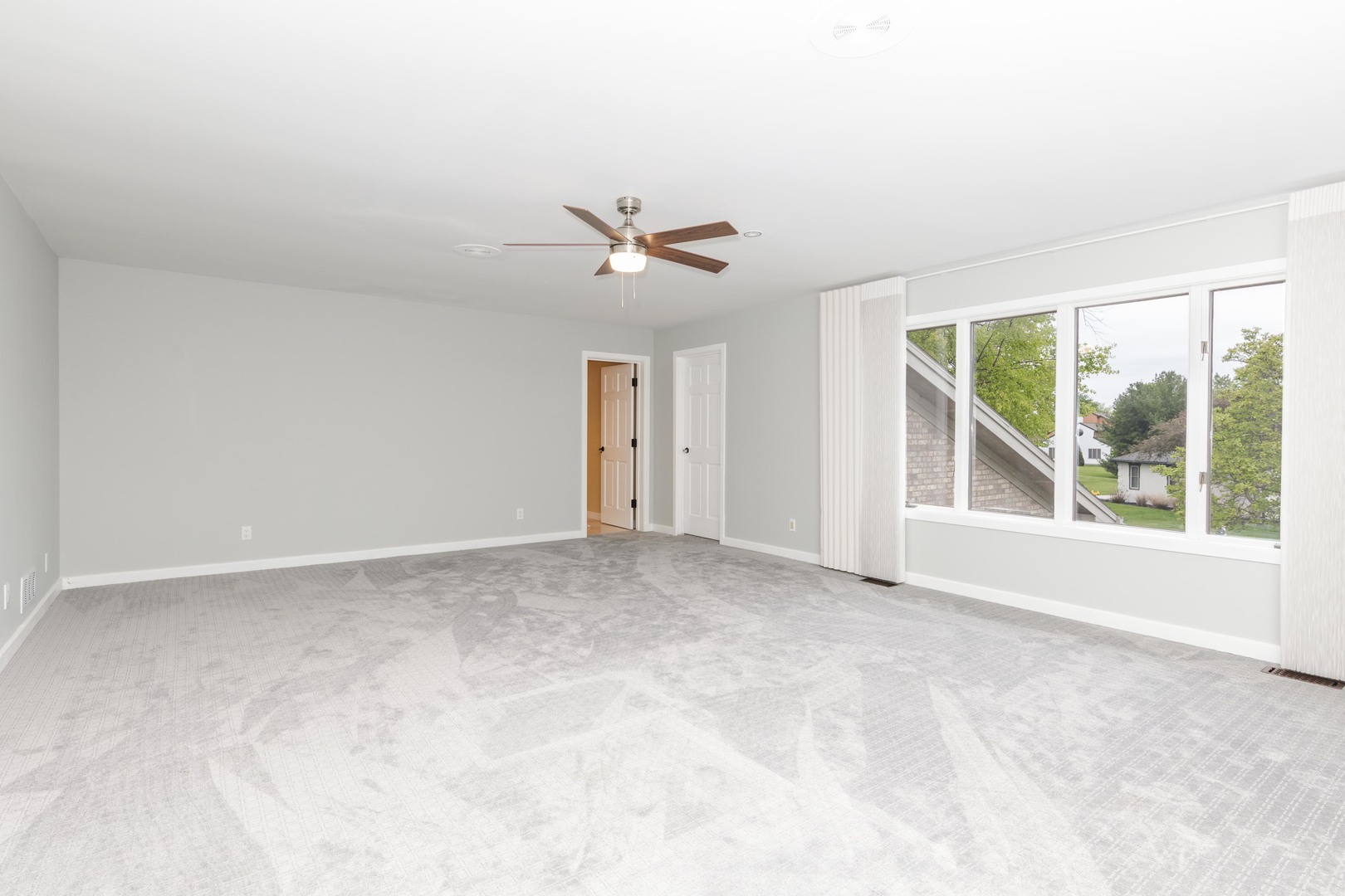 1810 Cardinal Court Pontiac, IL 61764 - Photo 60 of 88 an empty room with a ceiling fan and windows