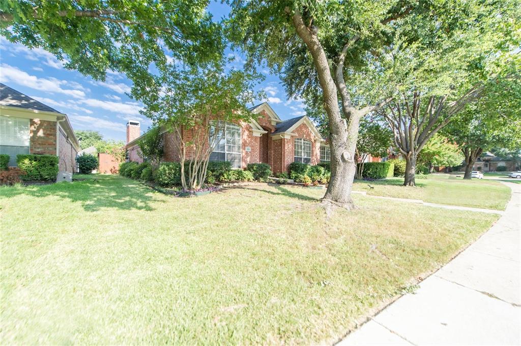 334 Touchdown Drive Irving, TX 75063 - Photo 4 of 32 Brick exterior with multiple windows and a prominent chimney