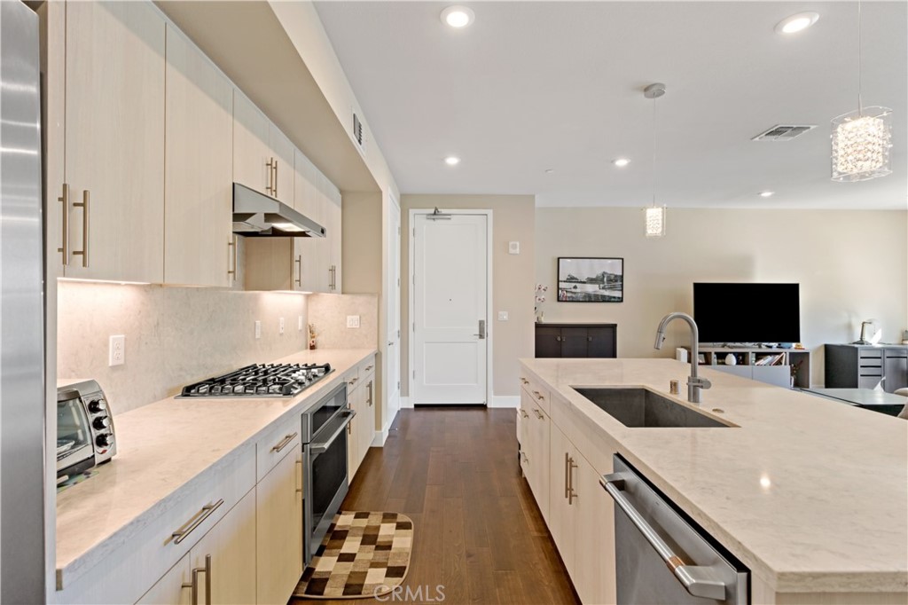 45009 Challenge Common, Unit 200 Fremont, CA 94538 - Photo 13 of 27 a large white kitchen with a stove a sink a microwave and refrigerator