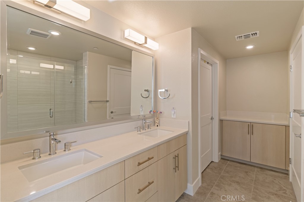 45009 Challenge Common, Unit 200 Fremont, CA 94538 - Photo 17 of 27 a bathroom with a double vanity sink mirror and double