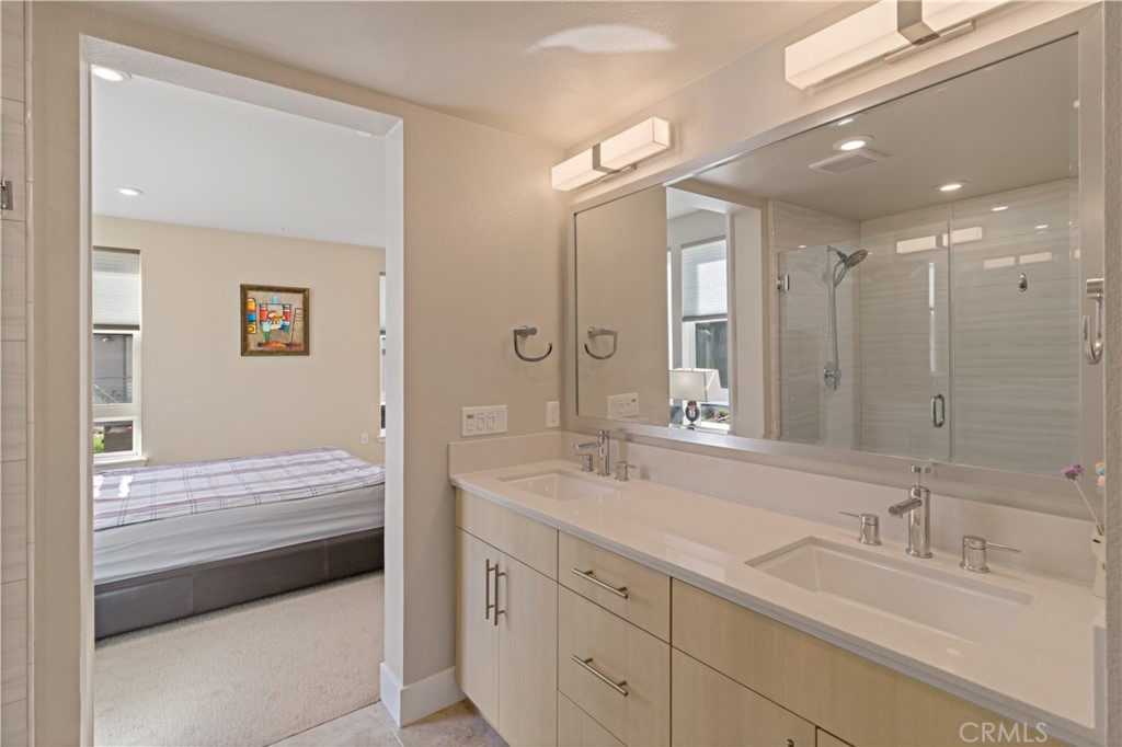 45009 Challenge Common, Unit 200 Fremont, CA 94538 - Photo 18 of 27 a en suite bathroom with a double vanity sink and a mirror