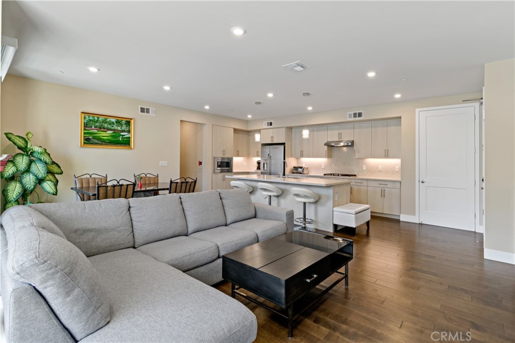 45009 Challenge Common, Unit 200 Fremont, CA 94538 - Photo 7 of 27 a living room with furniture and kitchen view