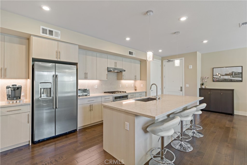 45009 Challenge Common, Unit 200 Fremont, CA 94538 - Photo 10 of 27 a kitchen with stainless steel appliances granite countertop a table chairs sink refrigerator and microwave