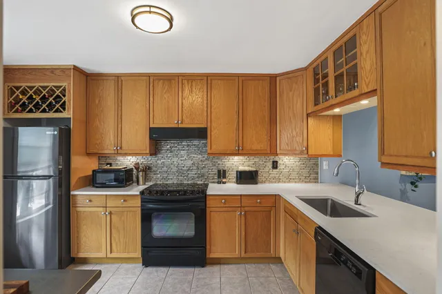 a kitchen with a sink cabinets and stainless steel appliances