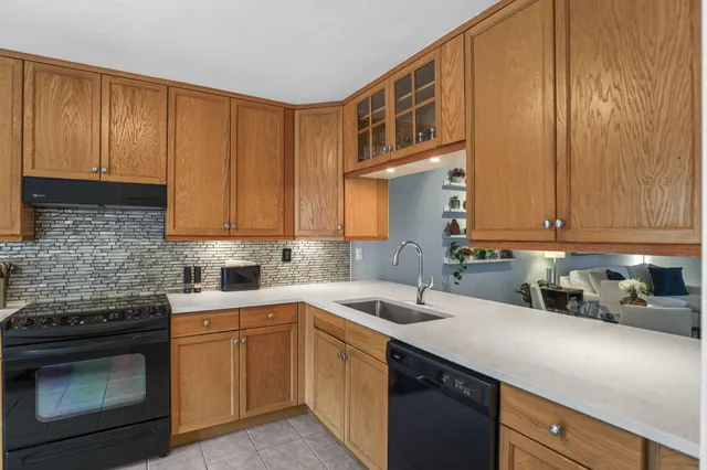 a kitchen with a sink stove and cabinets