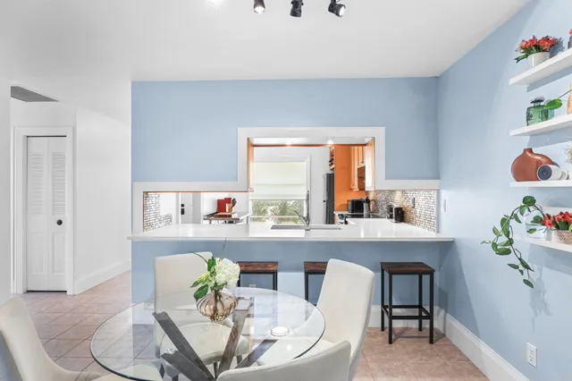 a living room with furniture and view of kitchen