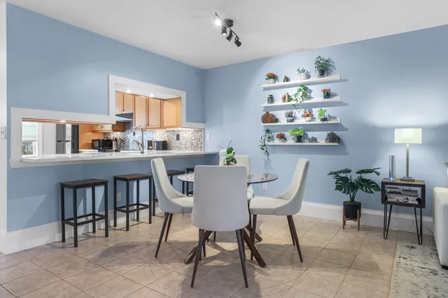 a living room with furniture a flat screen tv and a window