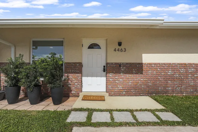 a view of front door and potted plants