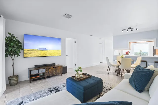 a bedroom with a bed and a potted plant