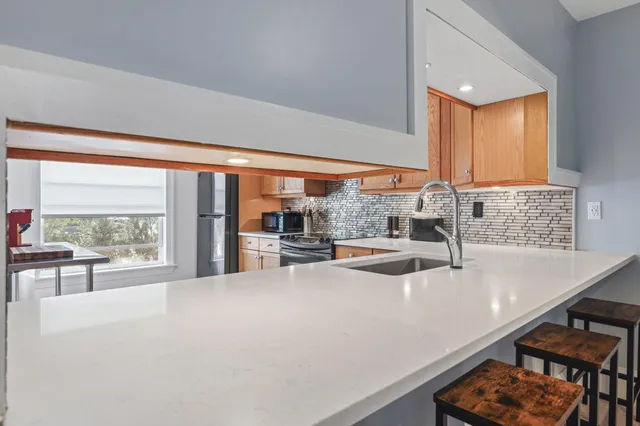a kitchen with a large window and a sink