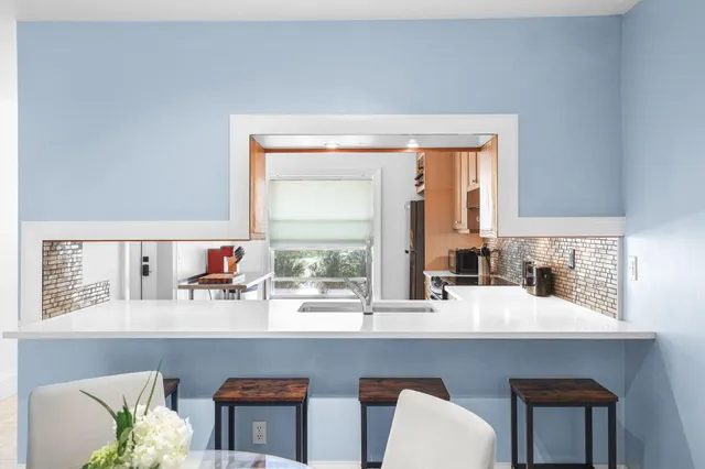 a kitchen with stainless steel appliances a sink and a window