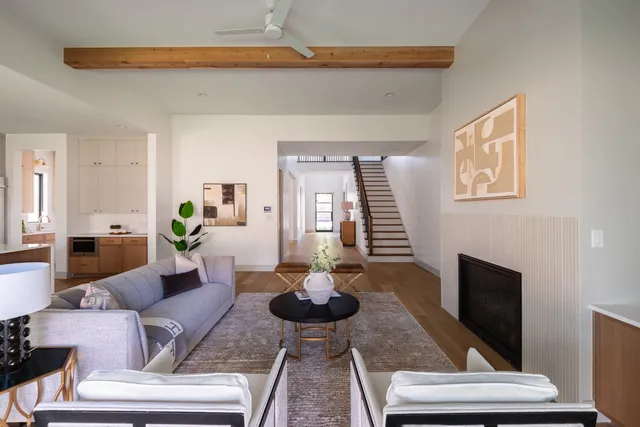 a spacious bedroom with a bed a couch and a large window