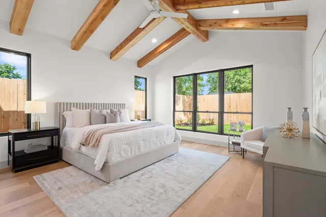 a bedroom with a bed a couch and a window