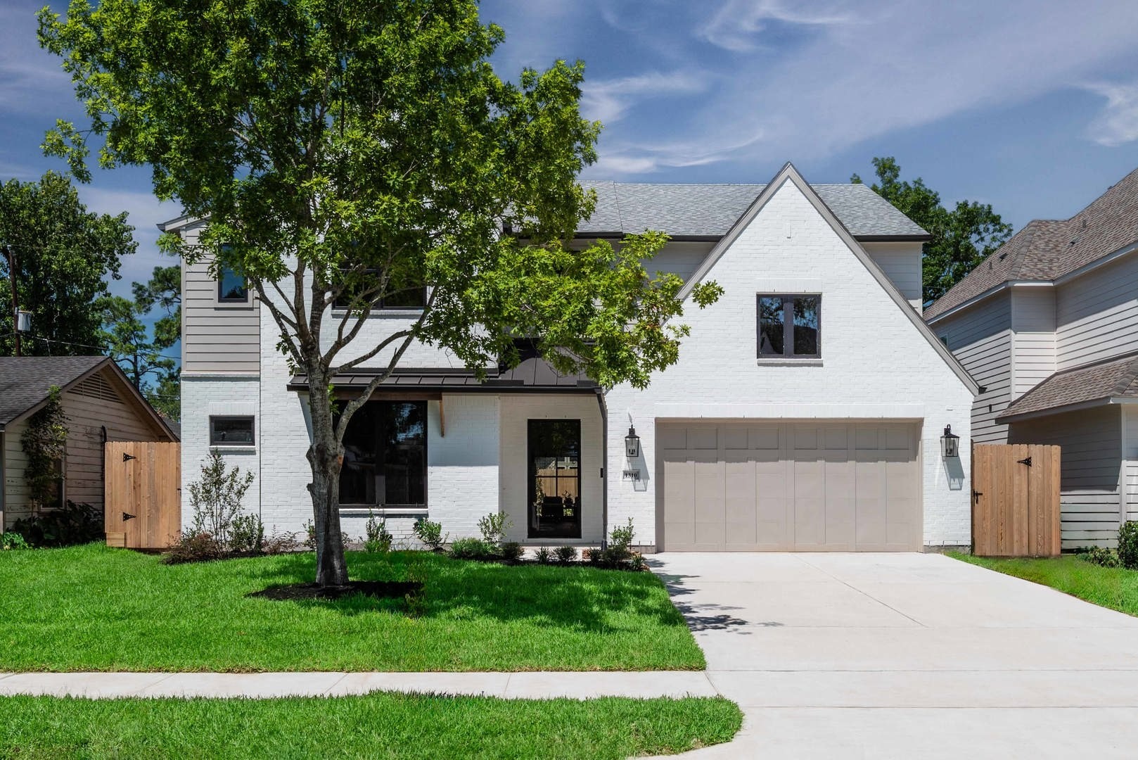 1310 Chantilly Lane Houston, TX 77018 - Photo 3 of 26 a view of a yard in front of a house with plants and large tree