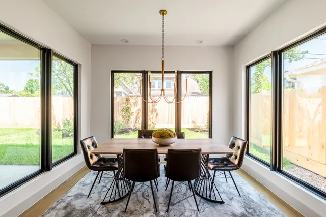 a kitchen with granite countertop a table chairs microwave and cabinets