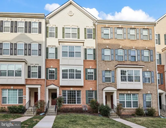 a front view of a residential apartment building with a yard