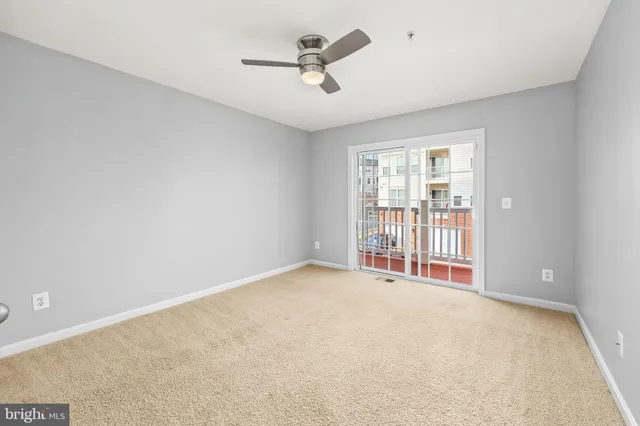 a view of a livingroom with a ceiling fan and window