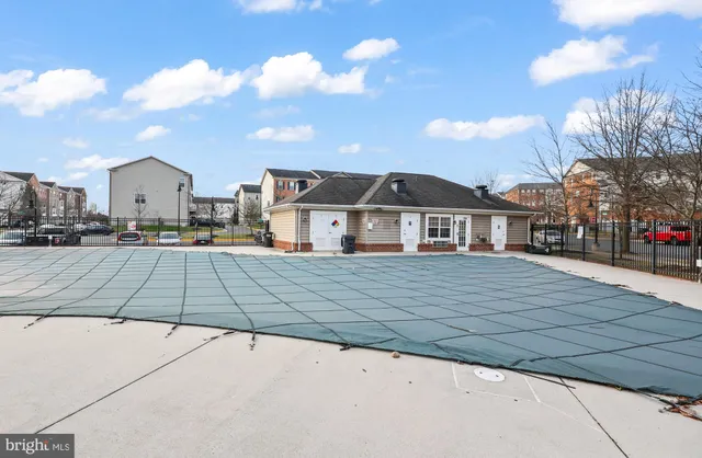 a view of a swimming pool with furniture
