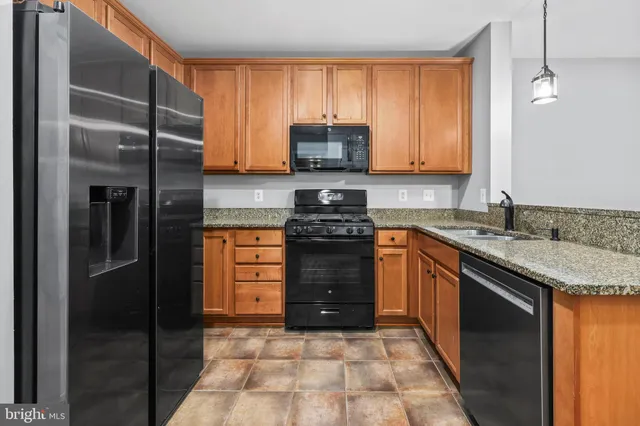 a kitchen with a stove a sink and a refrigerator