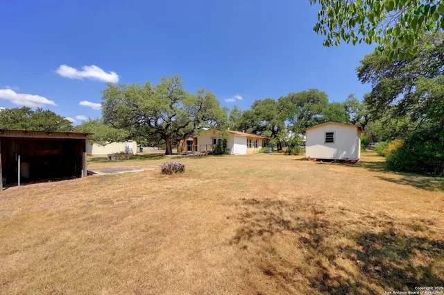 a swimming pool with outdoor seating and yard