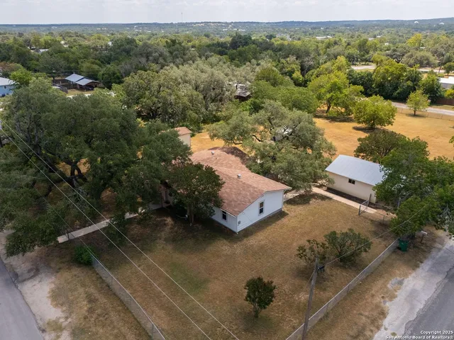 an aerial view of a house with a yard
