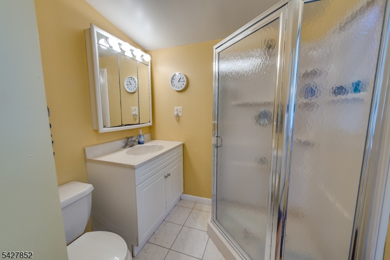 330 Lakeside Avenue Hopatcong, NJ 07821 - Photo 11 of 15 a bathroom with a granite countertop sink toilet and shower